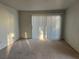 Living room with sliding door and vertical blinds at 5710 E Tropicana Ave # 2148, Las Vegas, NV 89122