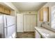 Kitchen with white appliances and light wood cabinets at 5954 Wabusca Way, Las Vegas, NV 89142