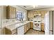 Galley kitchen, white appliances, light wood cabinets at 5954 Wabusca Way, Las Vegas, NV 89142