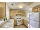 Efficient kitchen with white appliances and wood cabinets at 5954 Wabusca Way, Las Vegas, NV 89142