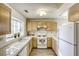 White appliances and light wood cabinets in this kitchen at 5954 Wabusca Way, Las Vegas, NV 89142