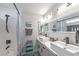 Modern bathroom with double vanity, bathtub, and gray tile at 6034 Pirates Delight Ave, Las Vegas, NV 89139