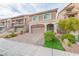 Two-story house with tan exterior, arched garage door, and landscaped front yard at 6034 Pirates Delight Ave, Las Vegas, NV 89139