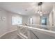 Upstairs hallway with wood-look floors and modern light fixtures at 6034 Pirates Delight Ave, Las Vegas, NV 89139