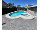 Inviting kidney shaped pool with attached spa and gray pavers at 6575 Ellerhurst Dr, Las Vegas, NV 89103