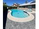 Inviting kidney shaped pool with attached spa and gray pavers at 6575 Ellerhurst Dr, Las Vegas, NV 89103