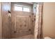 Large walk in shower with tile surround and multiple shower heads at 6575 Ellerhurst Dr, Las Vegas, NV 89103