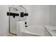 Clean bathroom with a shower, soaking tub, and black and white tile at 6821 Santa Isabel Ave # 104, Las Vegas, NV 89146