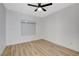 Bright bedroom with wood-look floors, ceiling fan and roll-up blinds at 6821 Santa Isabel Ave # 104, Las Vegas, NV 89146