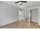 Well-lit bedroom with mirrored closet doors and wood-look floors at 6821 Santa Isabel Ave # 104, Las Vegas, NV 89146