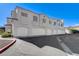 Exterior view of a multi-unit residential building with attached garages at 6821 Santa Isabel Ave # 104, Las Vegas, NV 89146