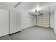 Attached garage with overhead storage and light gray flooring at 6821 Santa Isabel Ave # 104, Las Vegas, NV 89146