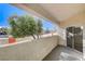 Private patio with treetop views and sliding glass door access at 6821 Santa Isabel Ave # 104, Las Vegas, NV 89146