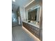 Modern bathroom with double vanity, large mirror, and walk-in shower at 700 W Carson Ave # 1405, Las Vegas, NV 89106