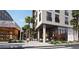 Upscale retail center with modern architecture, palm trees, and outdoor seating at 700 W Carson Ave # 2002, Las Vegas, NV 89106