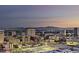 Expansive city view at dusk, highlighting the urban landscape and distant mountains at 700 W Carson Ave # 2506, Las Vegas, NV 89106