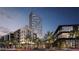 Modern high-rise building with palm trees and street view at dusk at 700 W Carson Ave # 3203, Las Vegas, NV 89106