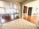 Bright and open entryway with wood and tile flooring, leading to dining and kitchen areas at 7458 Mezzanine View Ave, Las Vegas, NV 89178