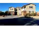 Two-story house with brick and siding, two-car garage, and landscaped yard at 7458 Mezzanine View Ave, Las Vegas, NV 89178