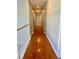 Bright hallway with wood flooring, leading to bedrooms at 7458 Mezzanine View Ave, Las Vegas, NV 89178