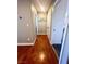 Hallway with wood floors and doors to bedrooms and bathroom at 7458 Mezzanine View Ave, Las Vegas, NV 89178