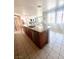 Kitchen island with granite countertop and stainless steel appliances at 7458 Mezzanine View Ave, Las Vegas, NV 89178