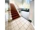 Elegant staircase with wood railing and tile flooring at 7458 Mezzanine View Ave, Las Vegas, NV 89178