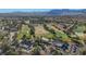 Aerial view of golf course, clubhouse, and tennis courts at 7500 Orange Haze Way, Las Vegas, NV 89149