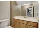 Small half bathroom with wood cabinets and a single sink vanity at 7500 Orange Haze Way, Las Vegas, NV 89149