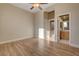 Light-filled bedroom with wood-look floors and en-suite bathroom at 7500 Orange Haze Way, Las Vegas, NV 89149