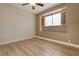 Bright bedroom with wood-look floors and window with shutters at 7500 Orange Haze Way, Las Vegas, NV 89149