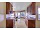 Kitchen with granite countertops, wooden cabinets and a view to the backyard at 7500 Orange Haze Way, Las Vegas, NV 89149