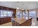 Large kitchen with granite island and breakfast bar at 7500 Orange Haze Way, Las Vegas, NV 89149