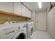 Laundry room with LG washer and dryer and built-in cabinets at 7500 Orange Haze Way, Las Vegas, NV 89149