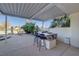 Outdoor kitchen with bar seating under covered patio at 7500 Orange Haze Way, Las Vegas, NV 89149