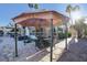 Patio seating area with a gazebo and stone flooring at 7500 Orange Haze Way, Las Vegas, NV 89149