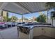 Covered patio with outdoor kitchen and bar seating overlooking the pool at 7500 Orange Haze Way, Las Vegas, NV 89149