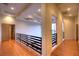 Elegant hallway with hardwood floors and modern railings at 7521 Yonie Ct, Las Vegas, NV 89117