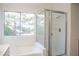 Clean bathroom with shower, bathtub and window at 7608 Botany Bay Dr, Las Vegas, NV 89128