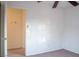 Simple bedroom with ceiling fan and access to hallway at 7608 Botany Bay Dr, Las Vegas, NV 89128