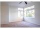 Well-lit bedroom with large windows and ceiling fan at 7608 Botany Bay Dr, Las Vegas, NV 89128