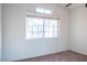 Well-lit bedroom featuring a large window and carpet flooring at 7608 Botany Bay Dr, Las Vegas, NV 89128