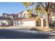 Two-story house with three-car garage and landscaped yard at 7608 Botany Bay Dr, Las Vegas, NV 89128