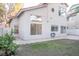 Rear view of house showing stucco siding and landscaping at 7608 Botany Bay Dr, Las Vegas, NV 89128