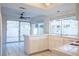 Kitchen with island, white cabinets and access to backyard at 7608 Botany Bay Dr, Las Vegas, NV 89128