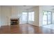 Living room with fireplace, hardwood floors and sliding glass doors at 7608 Botany Bay Dr, Las Vegas, NV 89128