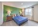 Bedroom with green accent wall and plush bedding at 7835 Pandora Sky St # 461, North Las Vegas, NV 89084