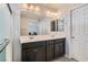 Double vanity bathroom with dark cabinets and a large mirror at 8272 Southern Cross Ave, Las Vegas, NV 89131