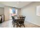 Bright dining room featuring a wooden table with six chairs and access to backyard at 8272 Southern Cross Ave, Las Vegas, NV 89131