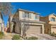 Two-story house with a two-car garage and a landscaped front yard at 8272 Southern Cross Ave, Las Vegas, NV 89131